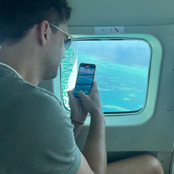 Billy looking out the window of the small plane over the Blue Hole