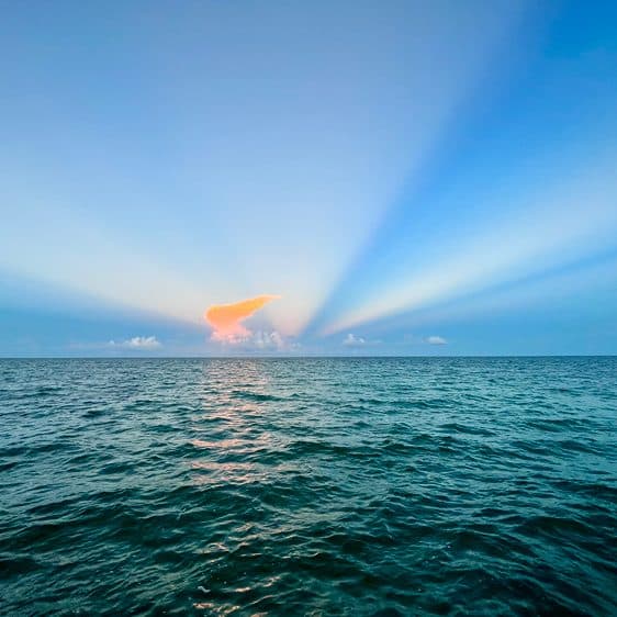 Sunbeams fanning out over the Caribbean at dusk