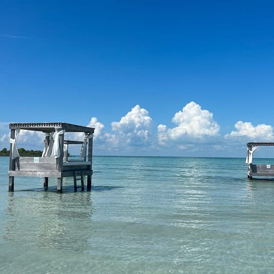 Overwater cabanas in shallow turquoise water