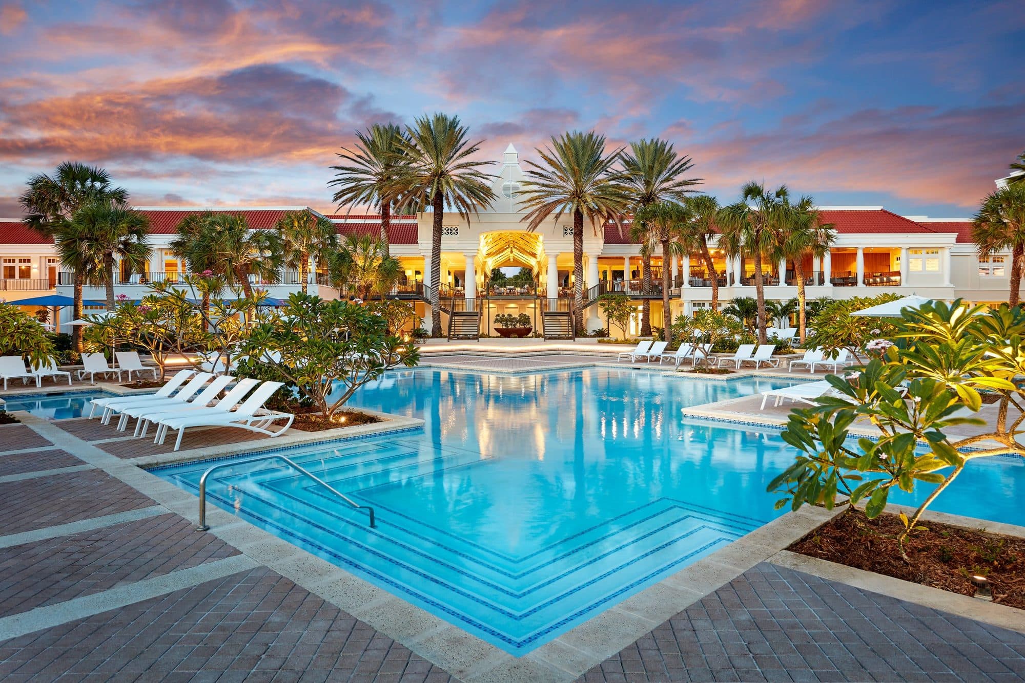 A resort pool glowing at dusk in Curaçao