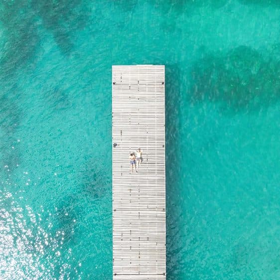 A long wooden pier seen from above