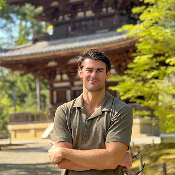 Billy standing in front of a temple pagoda