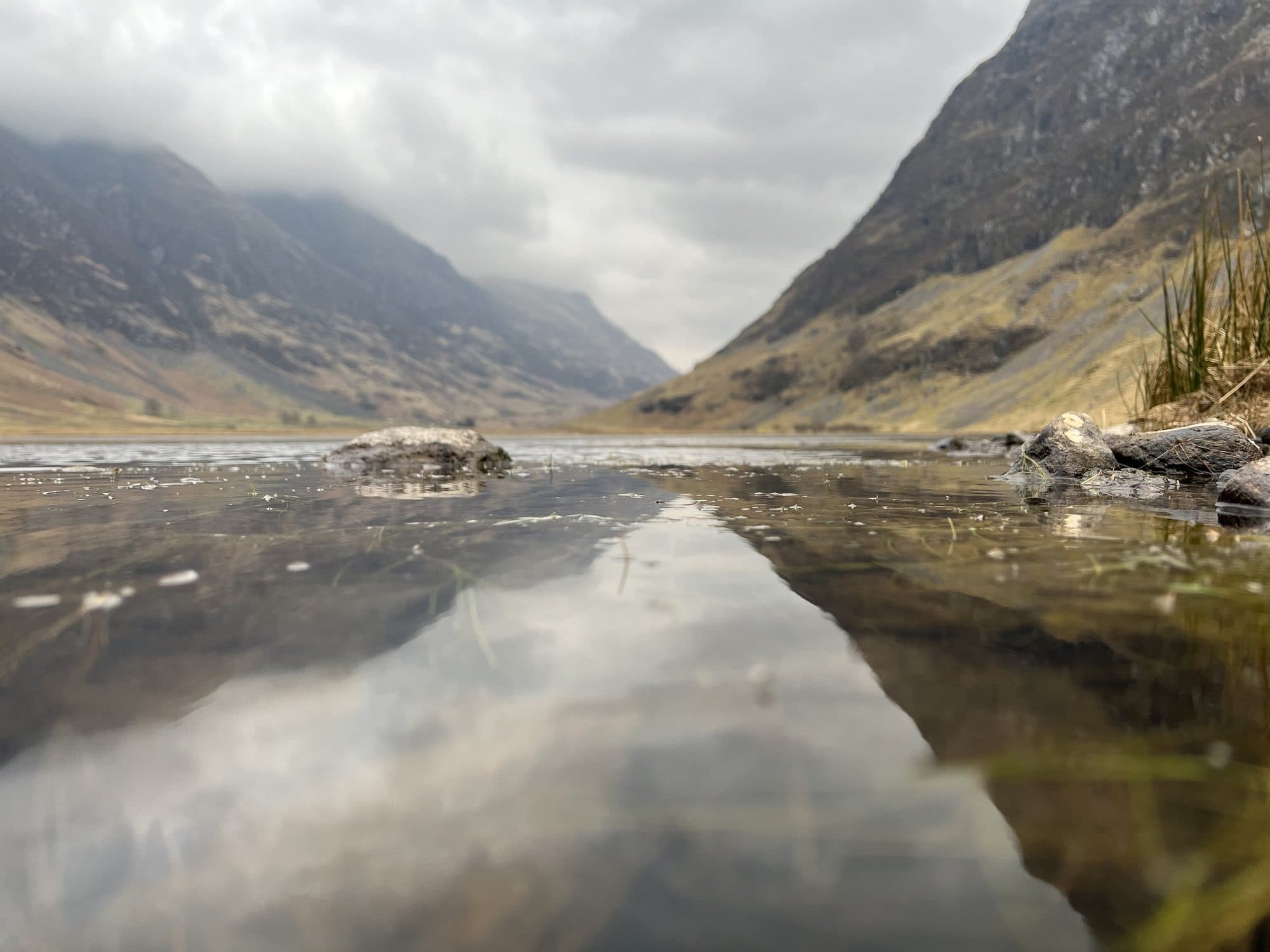 Mountains reflected in a still pool in Glencoe